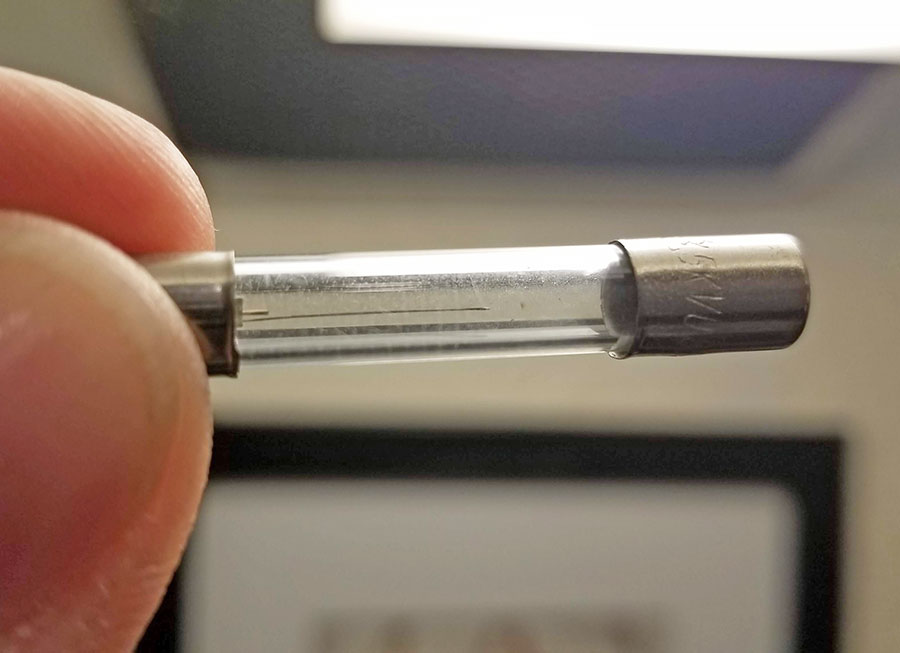 Close-up of a barrel fuse that is bad